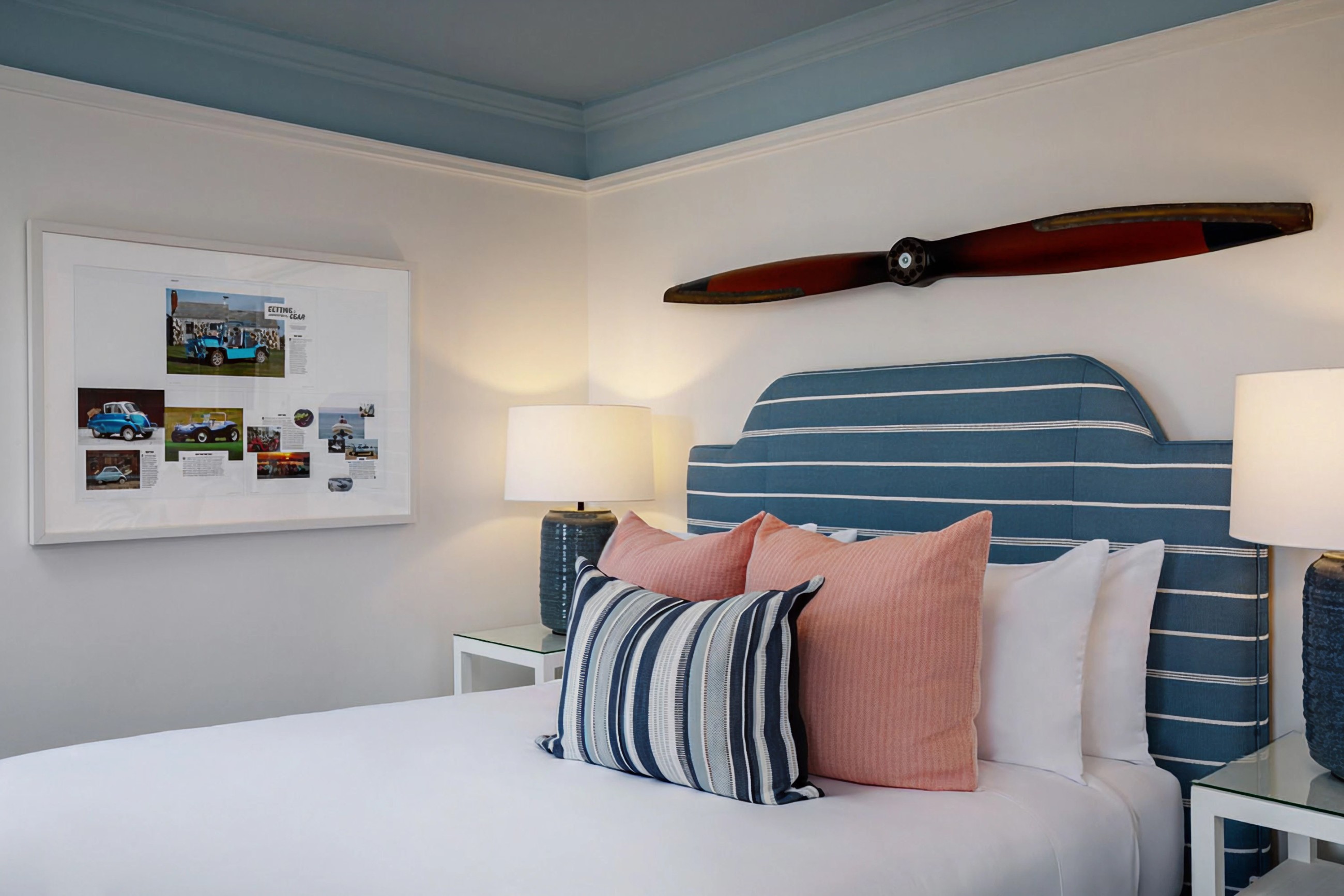Guest Room Featuring A Propeller Above The Headboard And Art On The Wall