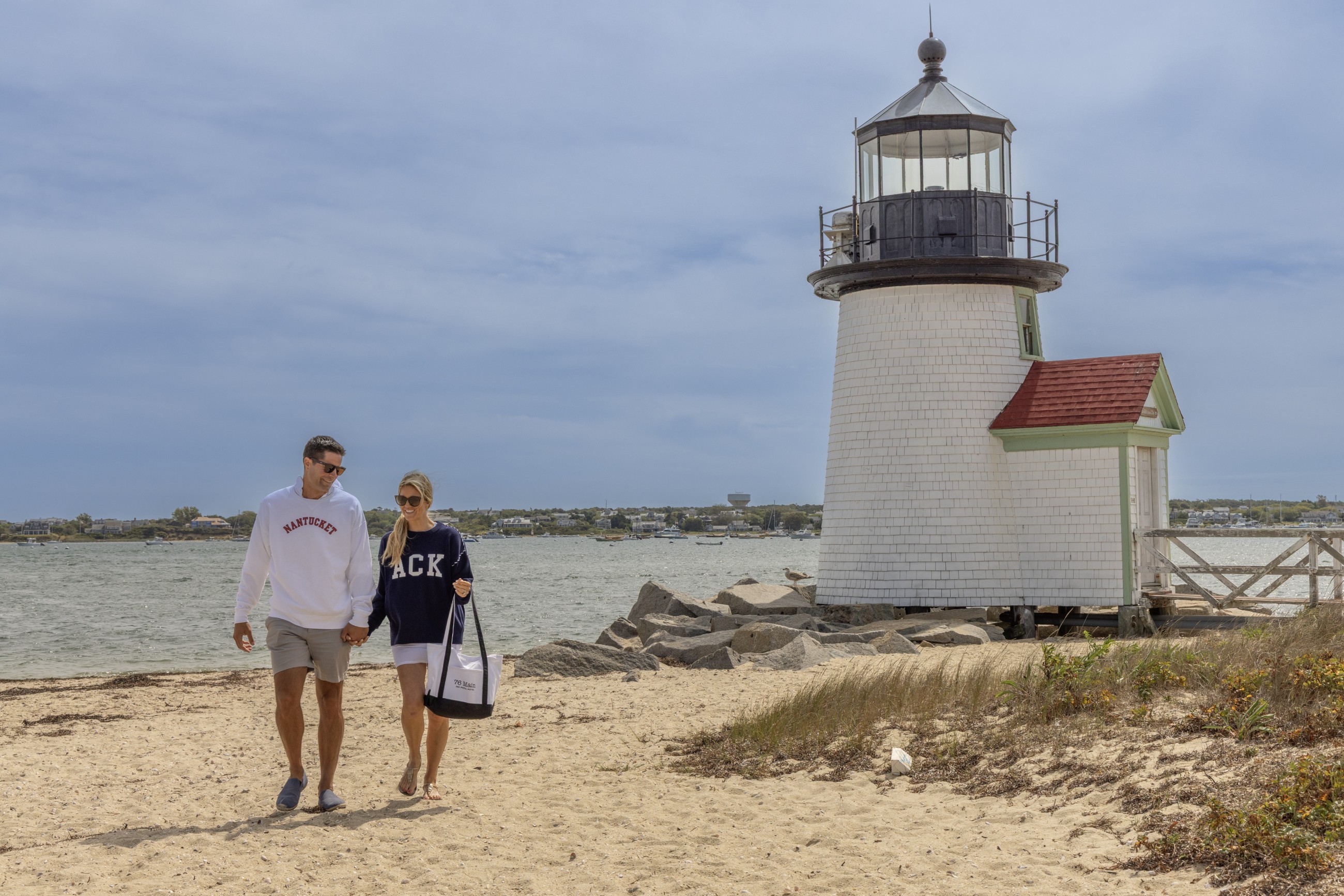 Couple Walking In Front Of The Brant Lighthouse