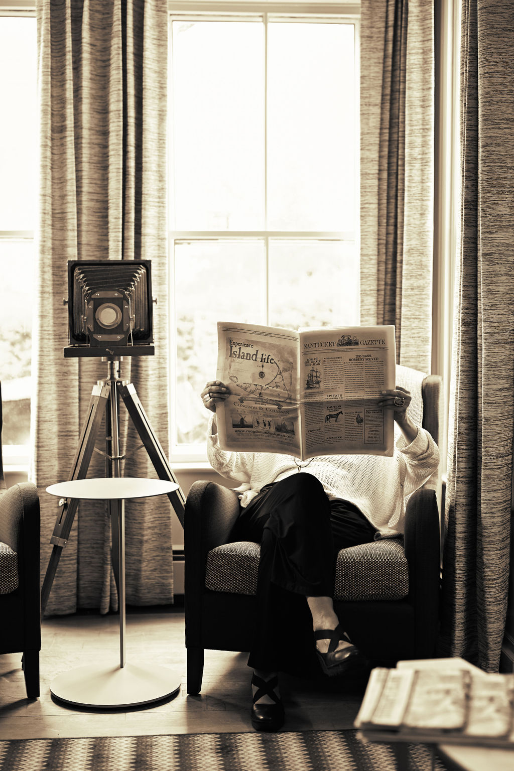 Person holding the Nantucket Gazette newspaper at 76 Main